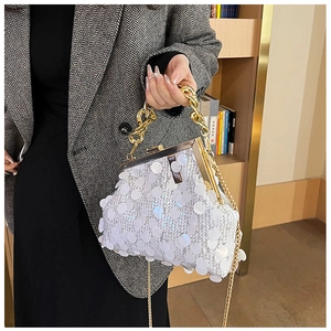 Close-up of white sequin crossbody bag featuring gold metal frame and thick chain handle