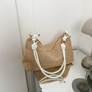 Minimalist straw woven tote bag with adjustable knotted shoulder strap and zipper closure