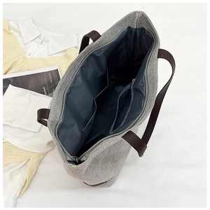 Internal view of linen tote bag with fabric lining, zipper pocket and brown leather straps