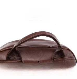 Close-up of the reinforced brown pebbled leather top handle with precise stitching details