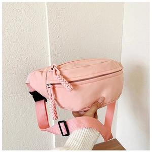 Close-up of pink nylon waist bag showing double zippers and adjustable strap detail