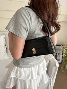 Minimalist black patent leather underarm bag with gold metal buckle for women