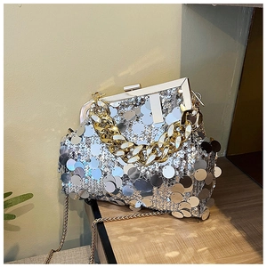 Detail of silver sequin evening bag featuring gold chunky chain handle and metal clasp