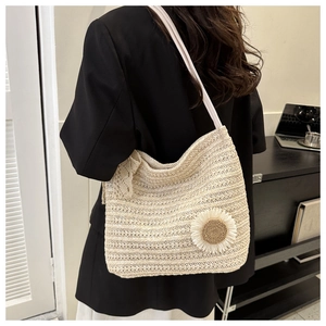 Detail of crochet tote bag with 3D daisy flower and white lace ribbon bow accent