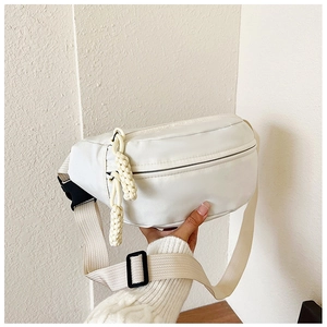 Detail of white sports waist bag with dual rope zippers and black plastic buckle