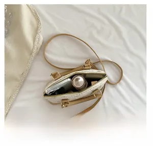 Top view of cream shell bag interior showing capacity for phone and cosmetics