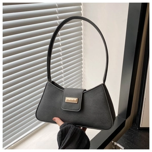 Close-up of black matte PU leather baguette bag with elegant golden metal clasp detail