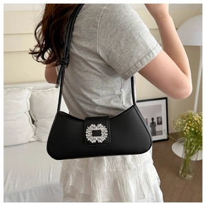 Close-up of black baguette underarm bag with a sparkling square rhinestone buckle