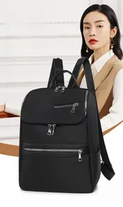 Close-up of minimalist black oxford backpack with premium metal zippers and leather trim