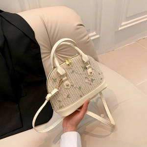 Chic cream straw shell bag with floral embroidery and adjustable crossbody strap