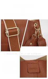 Detail der karamellfarbenen Ledertasche mit goldener Hardware und Webriemen