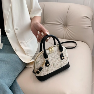 Straw shell bag with floral embroidery, black leather trim and circular handles
