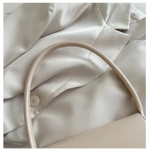 Dettaglio ravvicinato di un manico per borsa in pelle PU liscia con finitura opaca