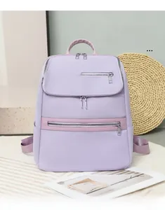 Detail view of the lilac oxford fabric backpack featuring multi-pocket zipper design