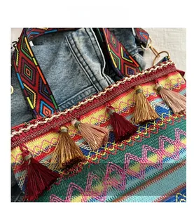 Close-up of bohemian bucket bag featuring colorful fringe tassels and woven patterns