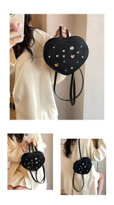 Close-up of black heart backpack with colorful rhinestones and metal star studs