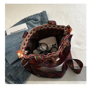 Detailed top view of a woven bucket bag showing its large interior capacity and items