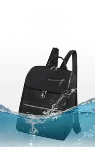 Detailed view of black water-resistant oxford backpack with professional splash test effect