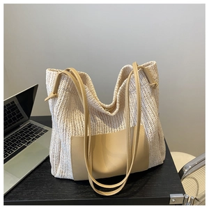 Detail of a beige woven tote bag with leather straps and large capacity for daily commute