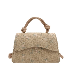 Chic woven straw crossbody bag with floral embroidery and a knotted top handle