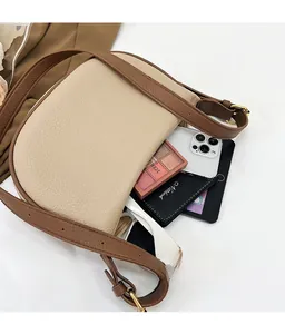 Spacious interior of a contrast leather saddle bag showing large storage capacity