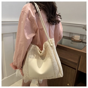 Detail of cream woven tote bag featuring high-quality faux leather pocket and texture
