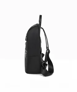Side view of minimalist black oxford backpack with silver zippers and wide straps