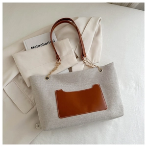 Detail von Nylon-Canvas-Tasche mit Ledertasche und goldener Ketten-Schulterriemen