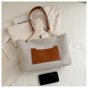 Detailansicht der Canvas-Einkaufstasche mit brauner Ledertasche und goldener Kette