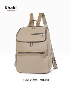 Side view of khaki oxford fabric backpack showing multi-layer storage and silver zippers