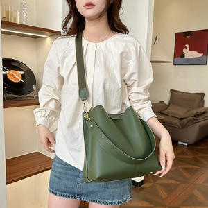 Retro dark green leather bucket bag with wide strap for shoulder and crossbody carry