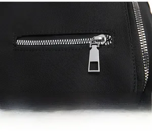 Close-up of high-quality silver metal zipper on durable black twill fabric backpack