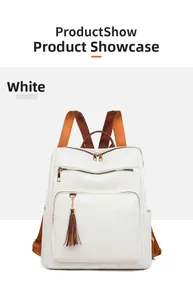 Close-up of white lychee textured leather backpack with brown straps and tassel detail