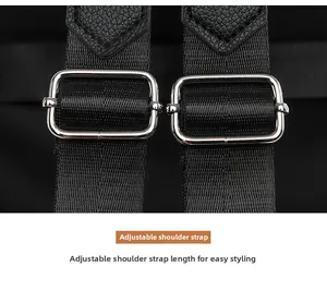 Close-up of adjustable shoulder straps with premium leather and silver metal buckles