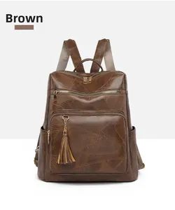 Detail view of coffee brown vintage backpack featuring geometric stitching and tassel zipper