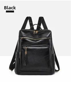 Detail view of black vintage backpack showing multi-zipper pockets and golden hardware