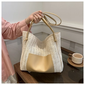 Detail showing high-quality straw weave texture and premium leather trim on a summer tote bag