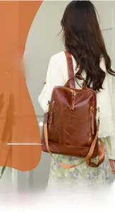 Close-up of vintage brown PU leather backpack with gold hardware and stitched textures