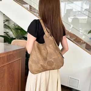 Brown vintage leather tote bag shown on shoulder featuring multi-compartment spacious design