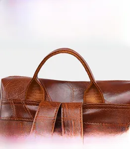 Detail of soft brown leather handles and reinforced stitching on a vintage backpack