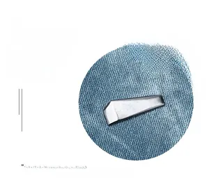 Detail of blue denim fabric texture and silver geometric metal buckle on the backpack
