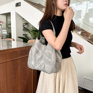 Detailed view of the large gray vintage tote bag with retro textures and side zipper