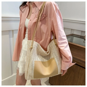 Detail of summer straw hobo bag with PU leather pocket and slim shoulder straps