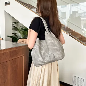 Detail of grey retro hobo shoulder bag with large capacity and vintage texture