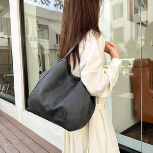 Detail view of large black vintage tote bag with side stitching and soft matte texture