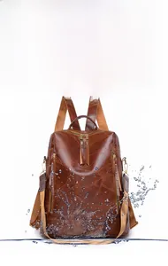 Detailed view of waterproof PU leather backpack surface with splash effect