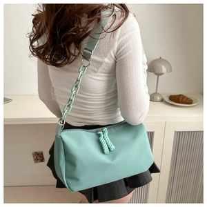 Mint green nylon shoulder bag with thick plastic chain and woven knot zippers