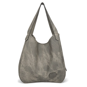 Close-up of washed gray canvas texture and brand leather patch on large tote bag