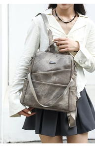 Detail of grey vintage textured backpack with tiered pleats and adjustable strap