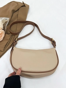 Chic off-white leather hobo bag with brown trim and adjustable gold-tone buckle